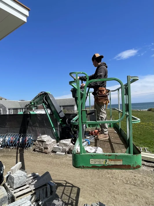 Friendly HM Home Improvement contractor in front of a Rhode Island home